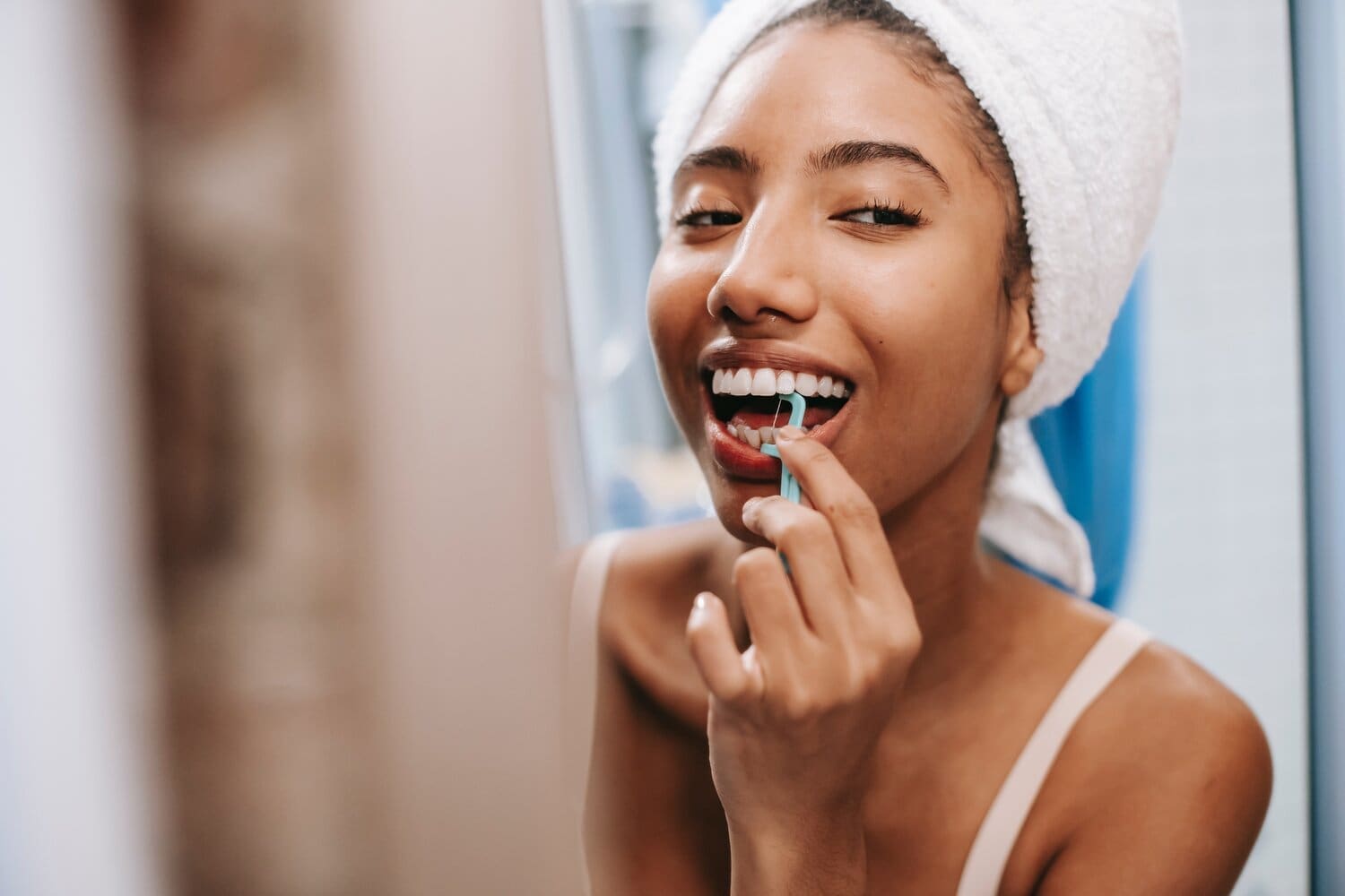 woman flossing her teeth