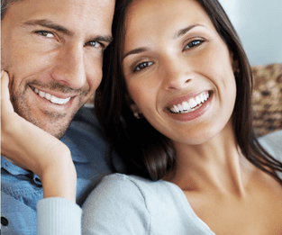 Man and woman smiling together with dental bridges in Lexington