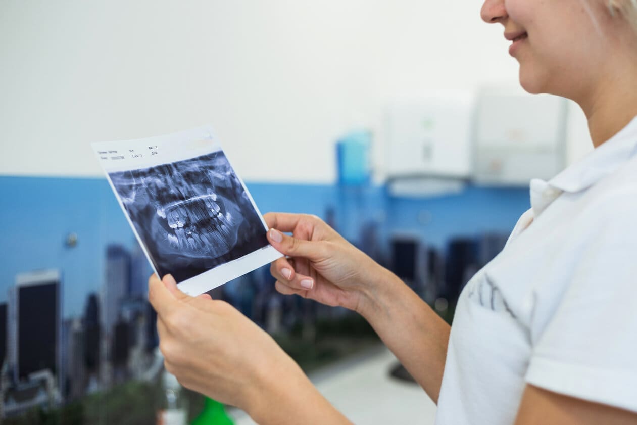 Young female dentist working in dental office.