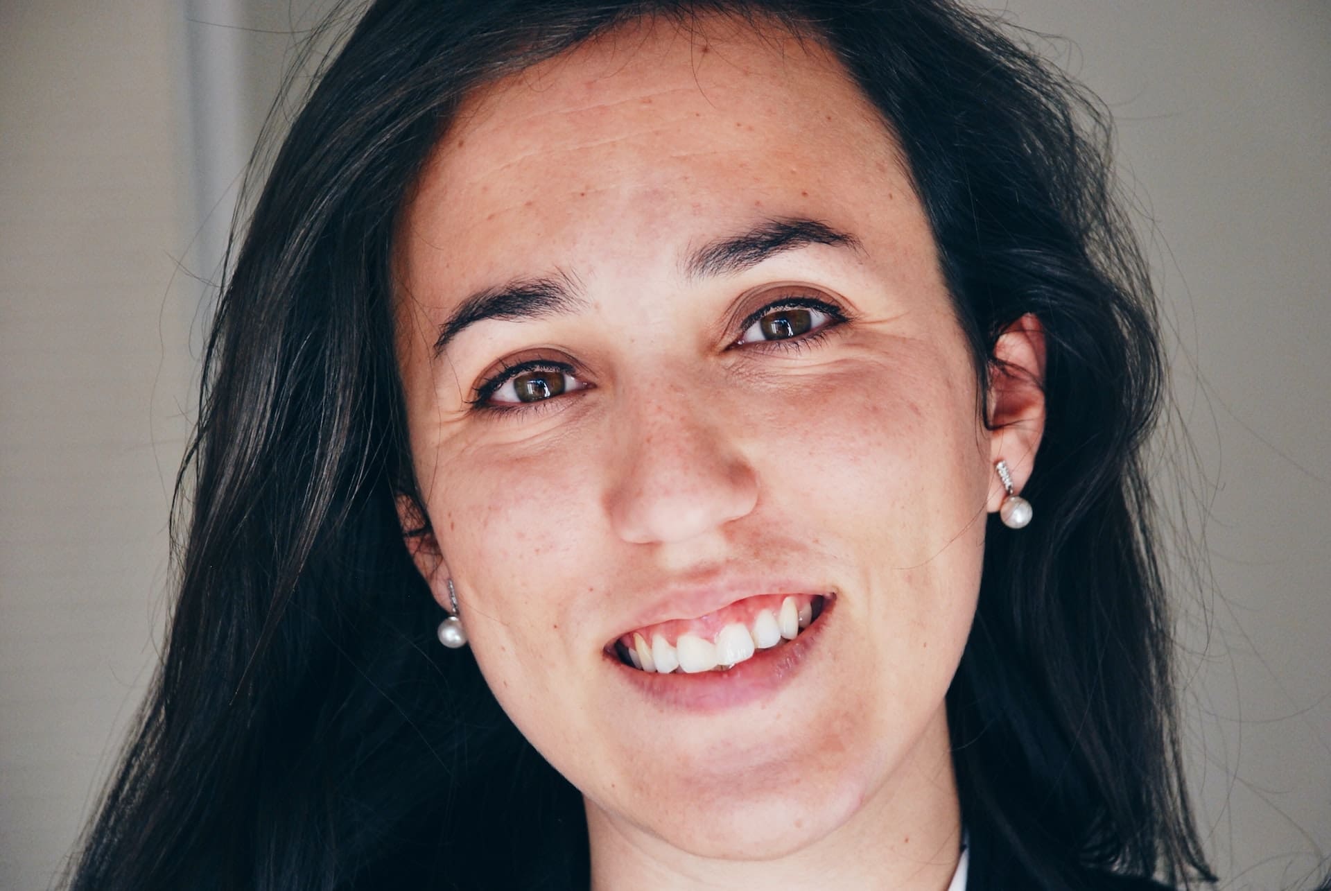 Smiling woman with pearl earrings