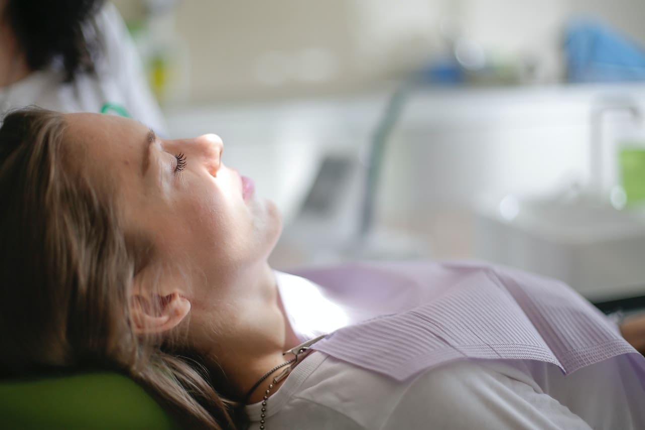 Woman relaxing in dental chair thanks to nitrous oxide sedation dentistry in Lexington