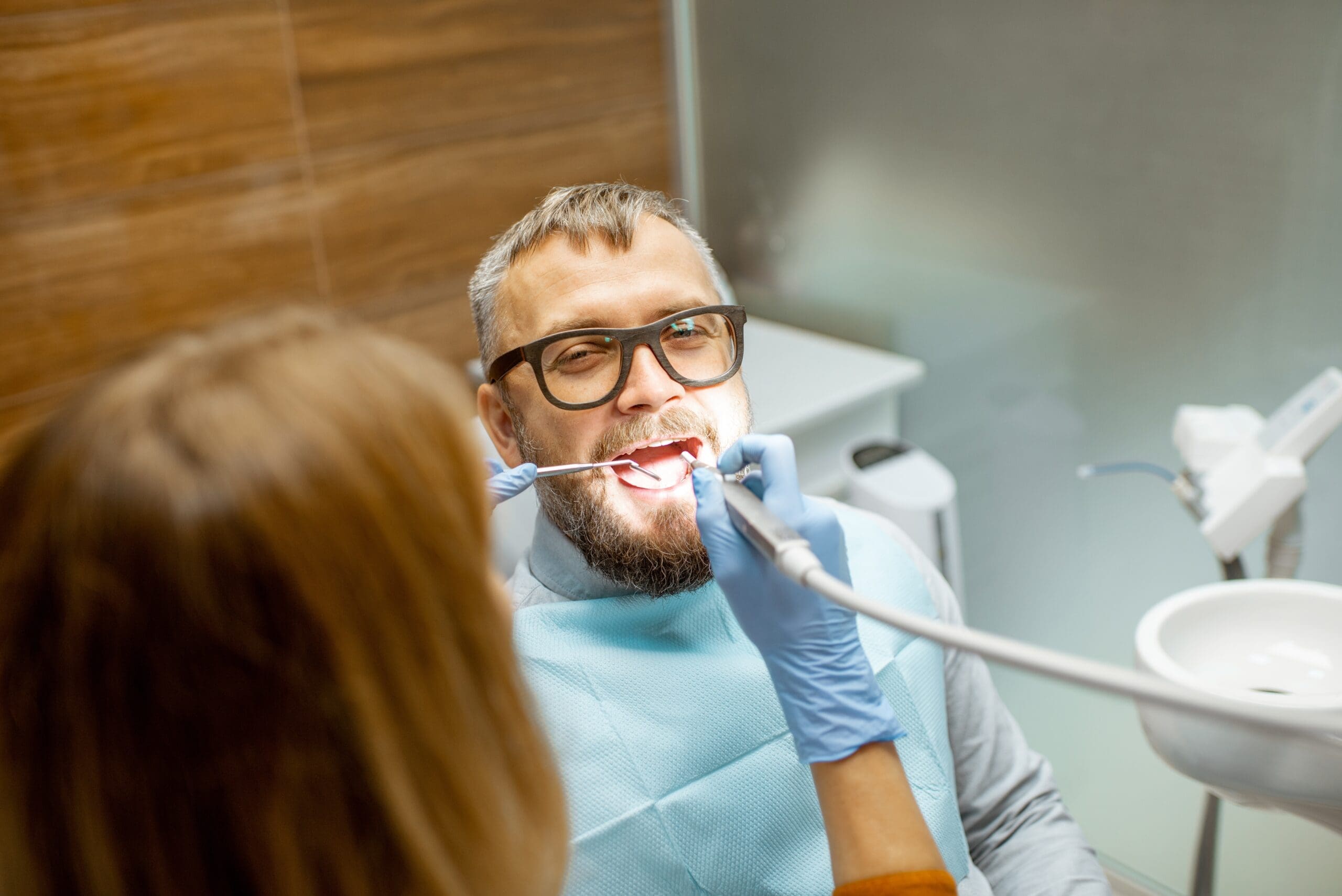 Older man receiving a dental exam from his cosmetic dentist in Lexington