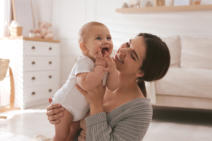 Happy mom and infant playing together