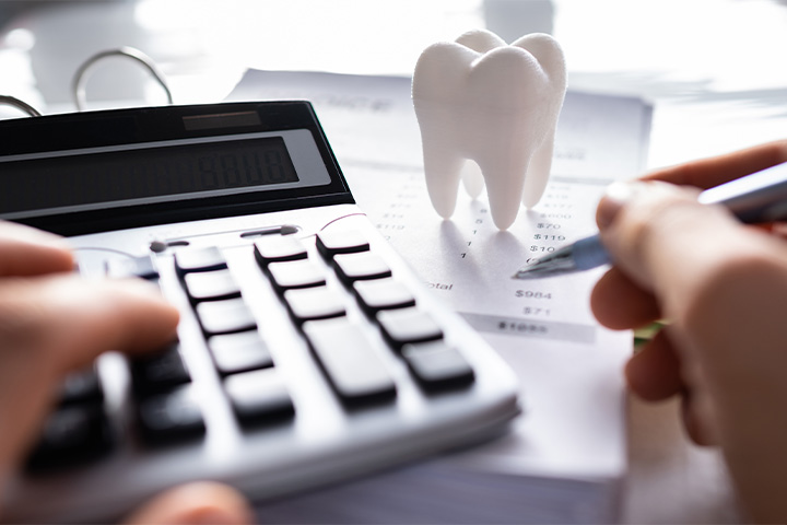 A patient calculating the cost of their dental care