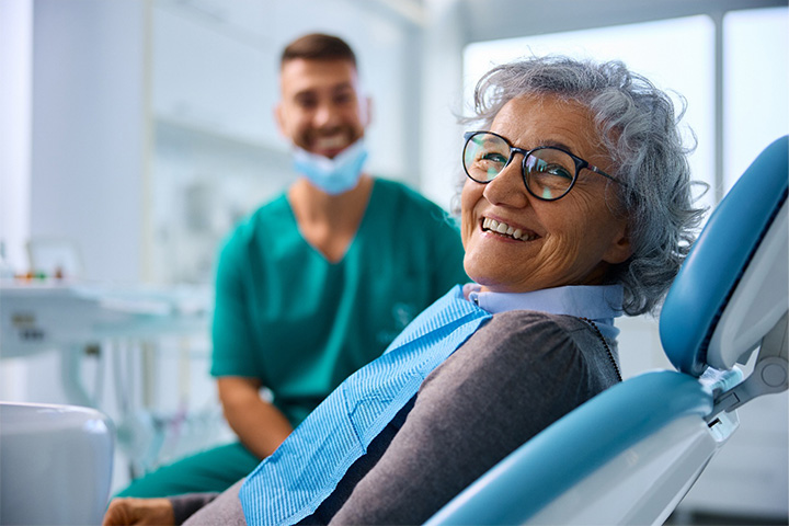 A satisfied, smiling senior woman looking at the camera.