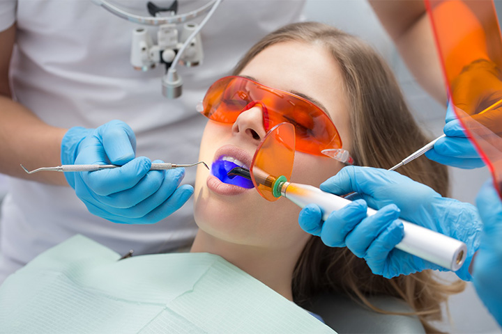 Woman having a tooth-colored filling put in place.