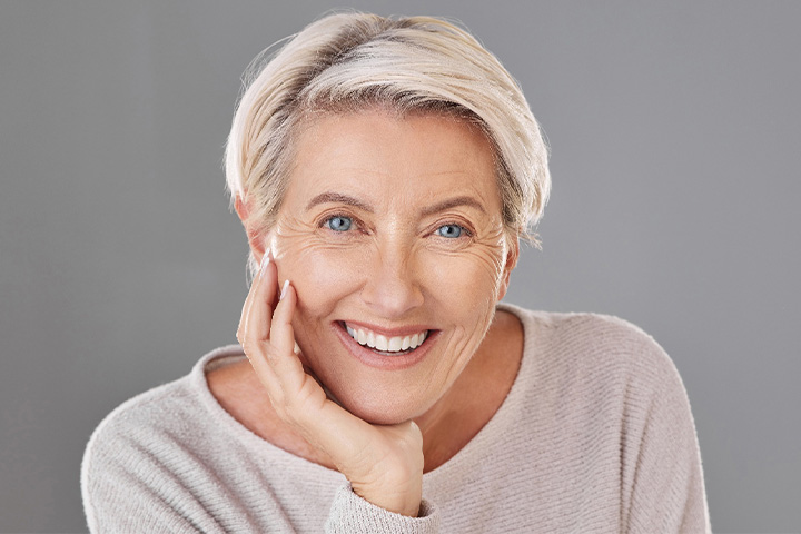 Woman smiling confidently with her dentures in Lexington.